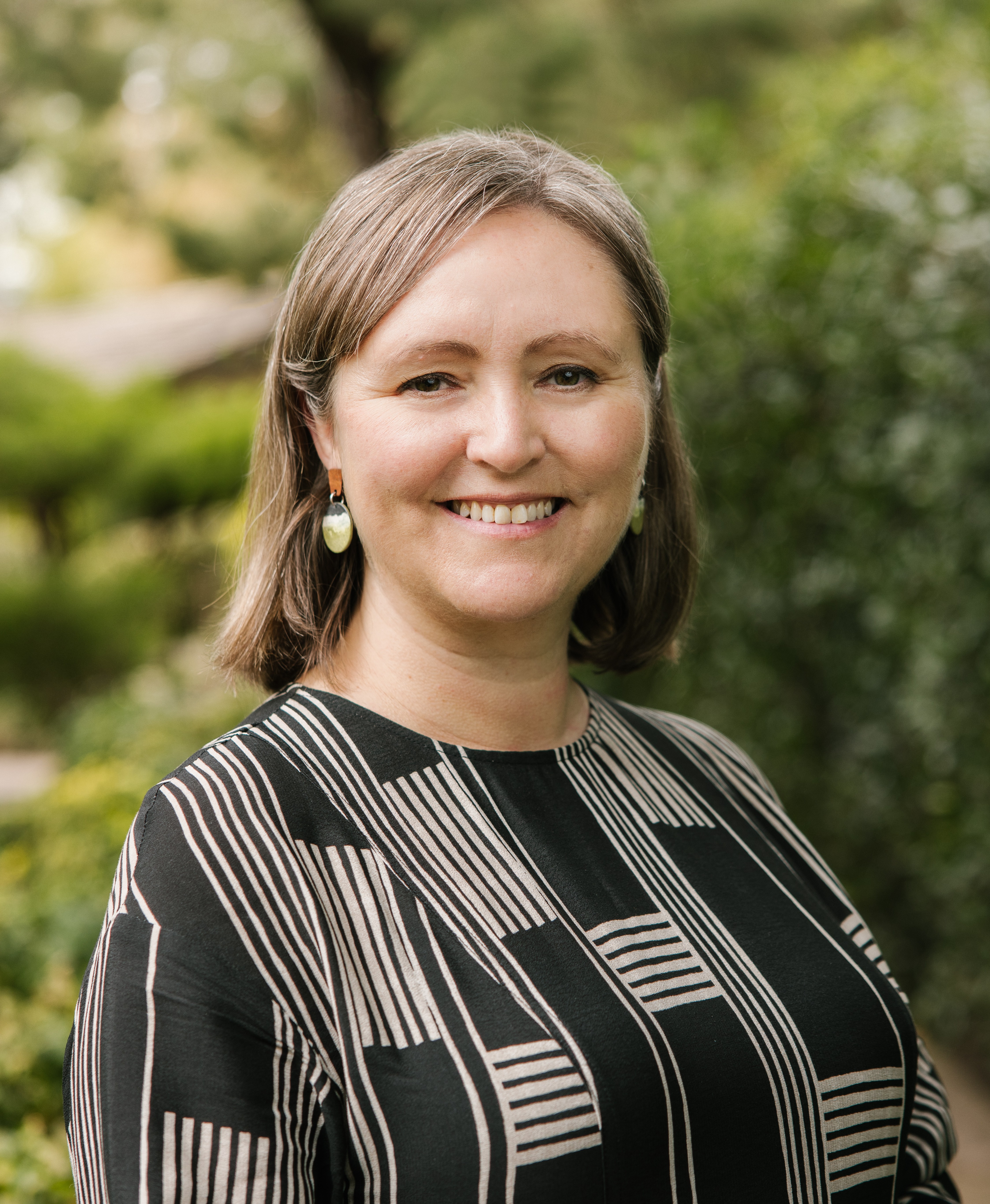 Image of Melanie Selwood with blurred leafy background