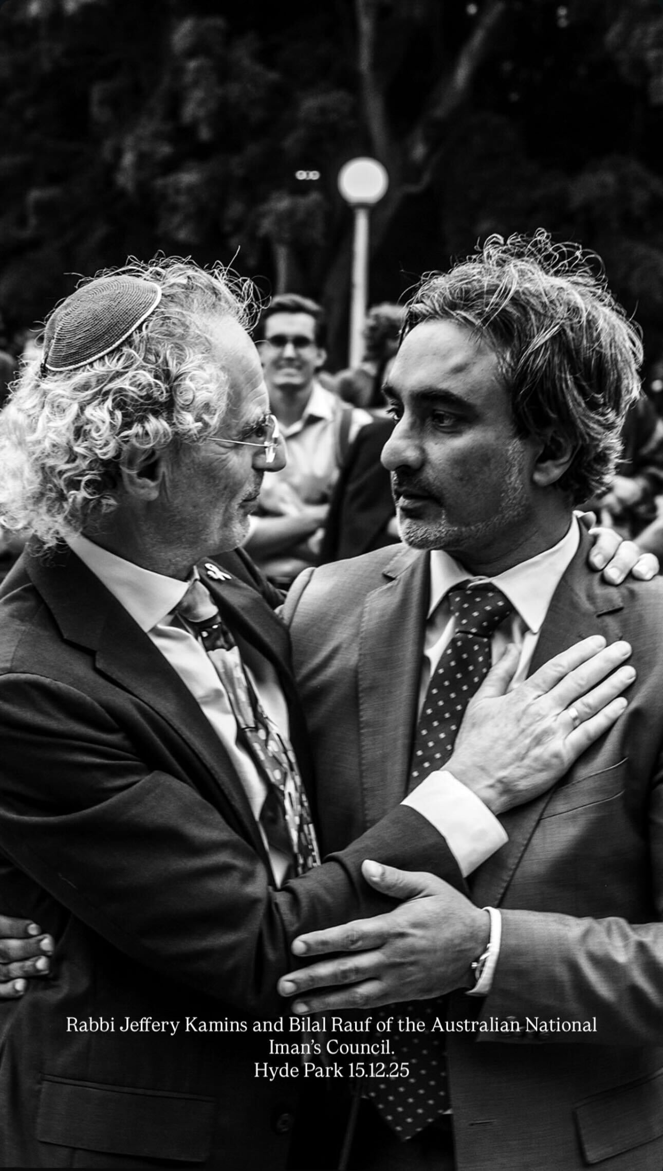 Rabbi Jeffrey Kamins of Emanuel Synagogue and Bilal Rauf of the Australian National Imams Council embracing at Hyde Park on Monday