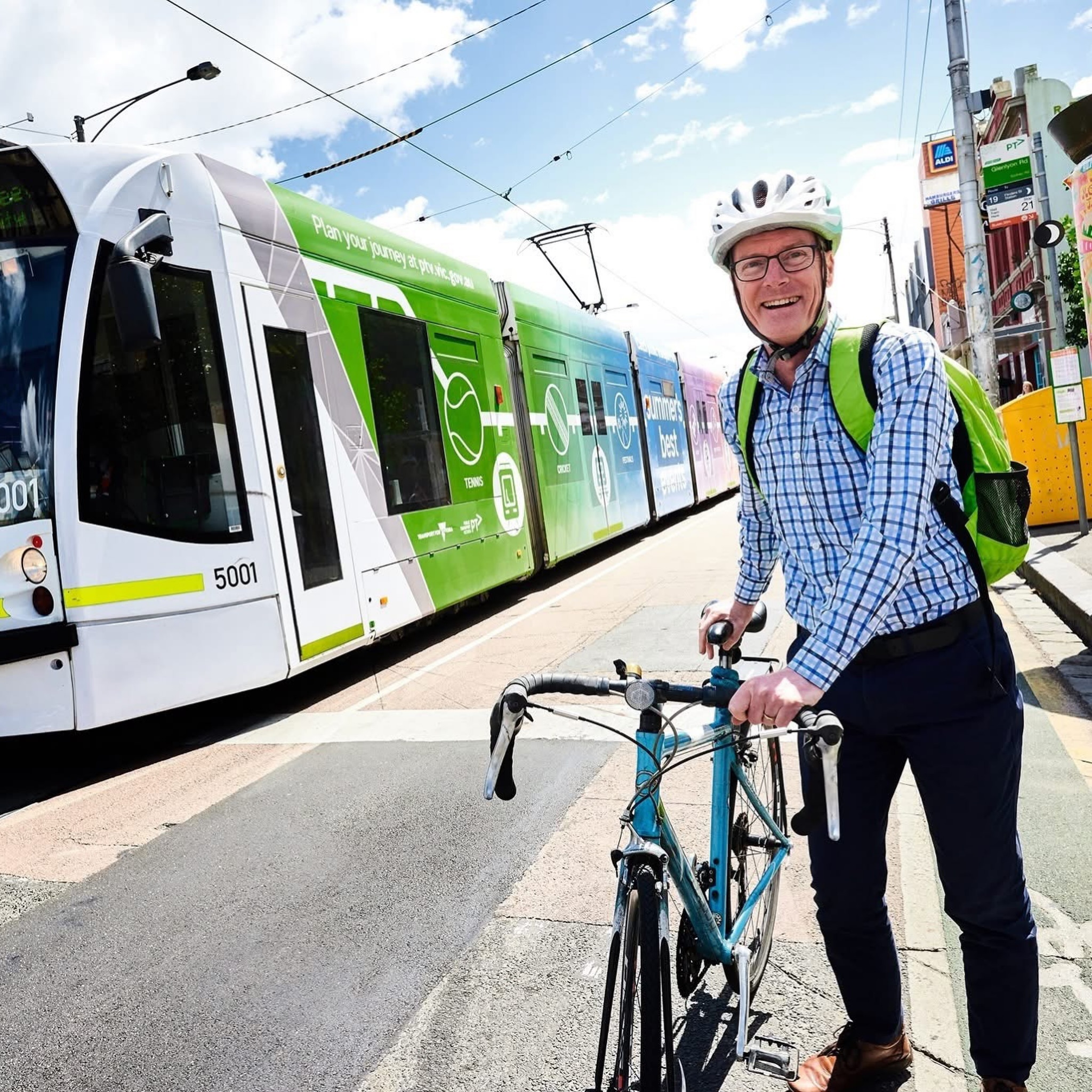 Image of Tim Read on his bike in high vis near a Melbourne tram