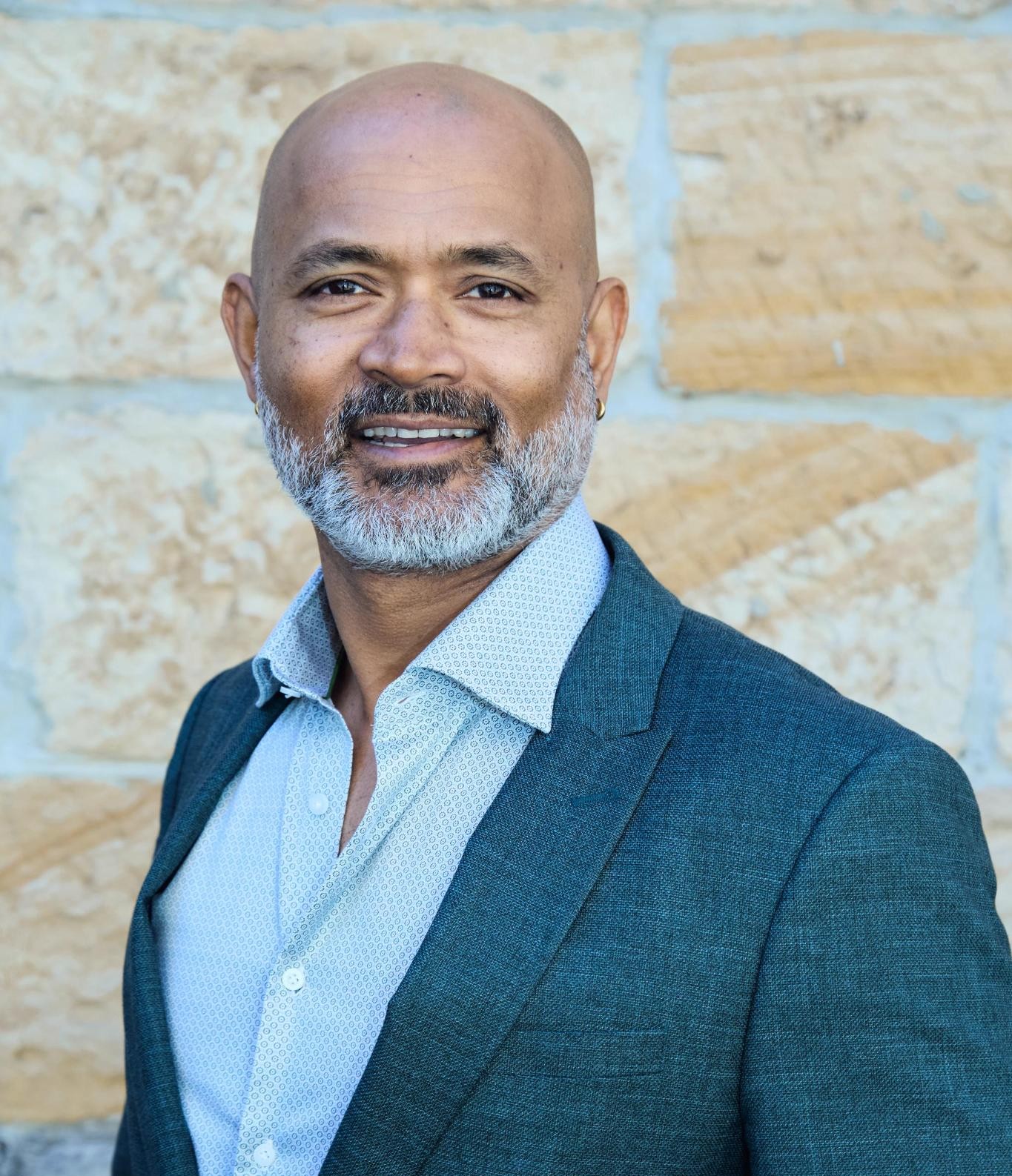 Candidate for Rockdale Dushy De Silva profile image in front of rock background