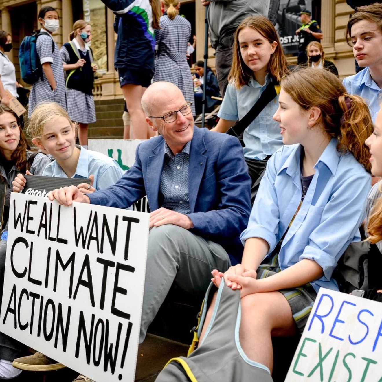 Tim Read with school students at climate strike sign reads we want climate action now