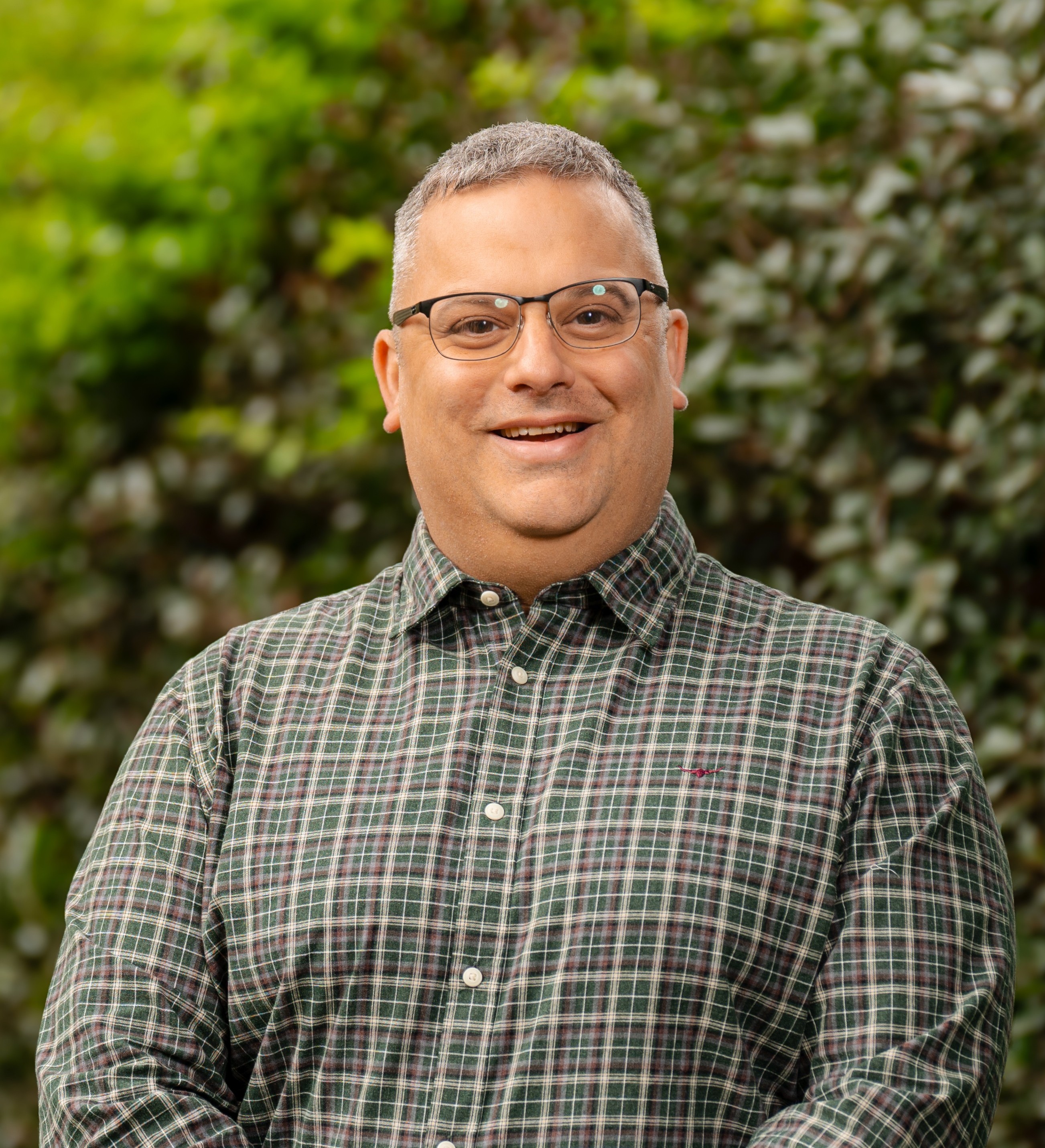 Josh Andersen-Ward in front of a green leafy background