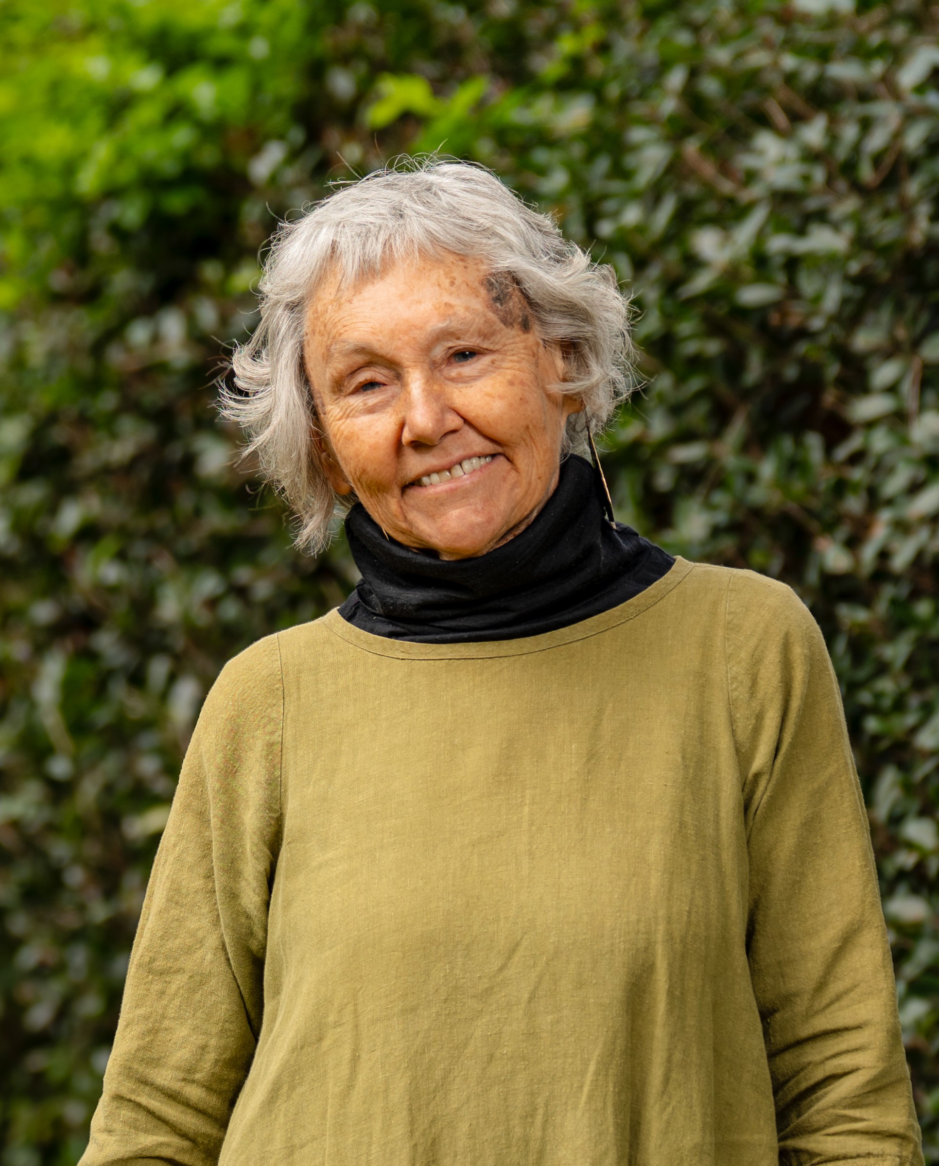 Susan Ditter in front of a green leafy background