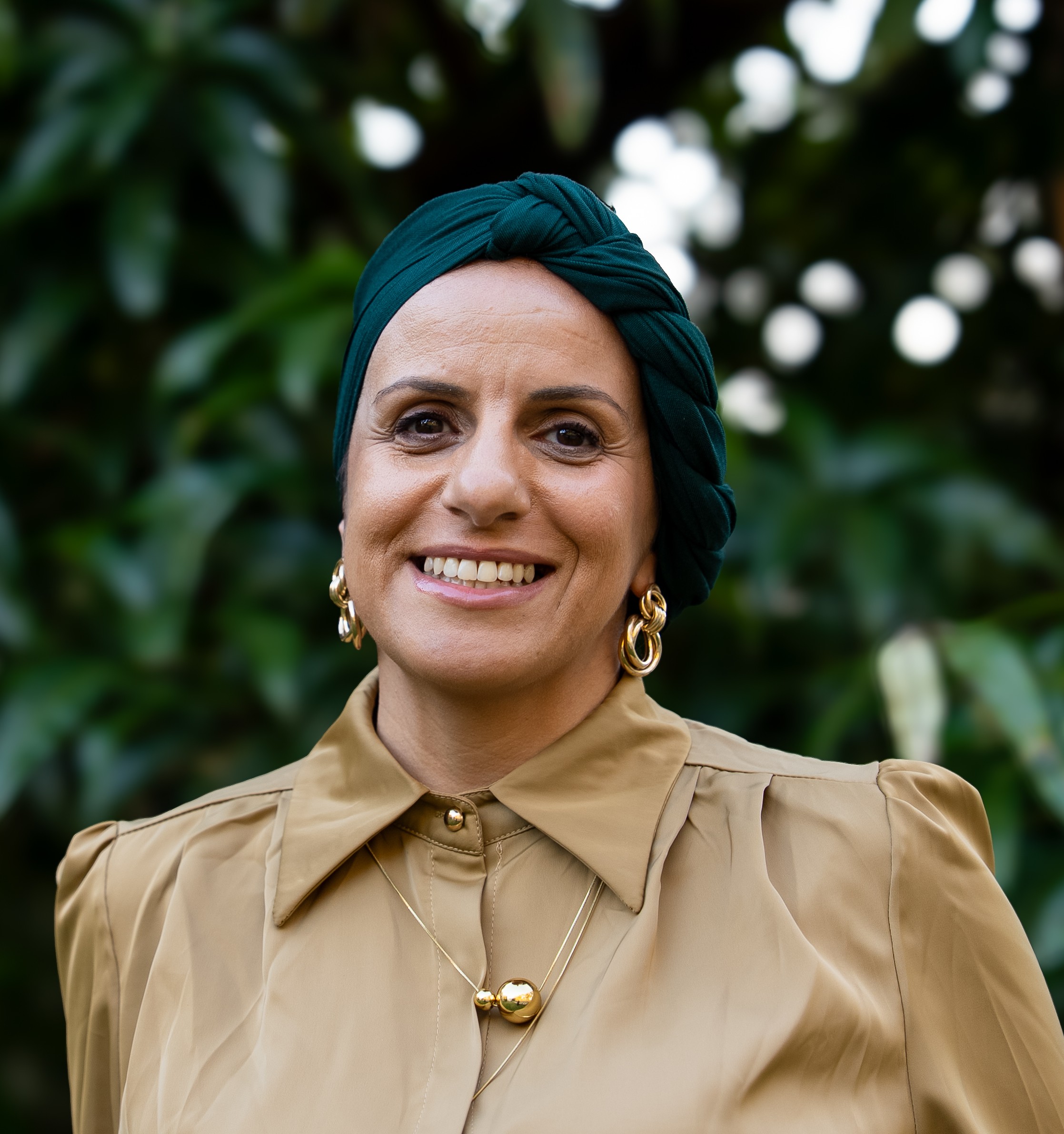 Greens candidate for Kogarah Yomna Touni in front of a leafy backdrop