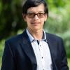 Profile picture of Greens candidate for St Albans, Bao Huynh. Bao is standing in front of blurred out parklands. Bao is wearing a light blue shirt with a dark blazer