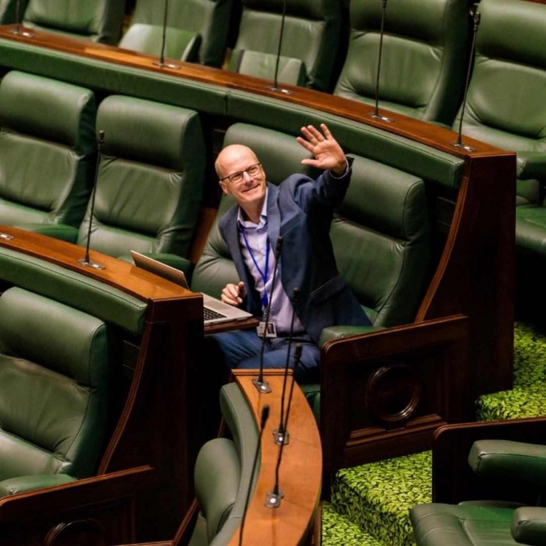 Image of Tim Read waving in the Lower House of Victorian Parliament
