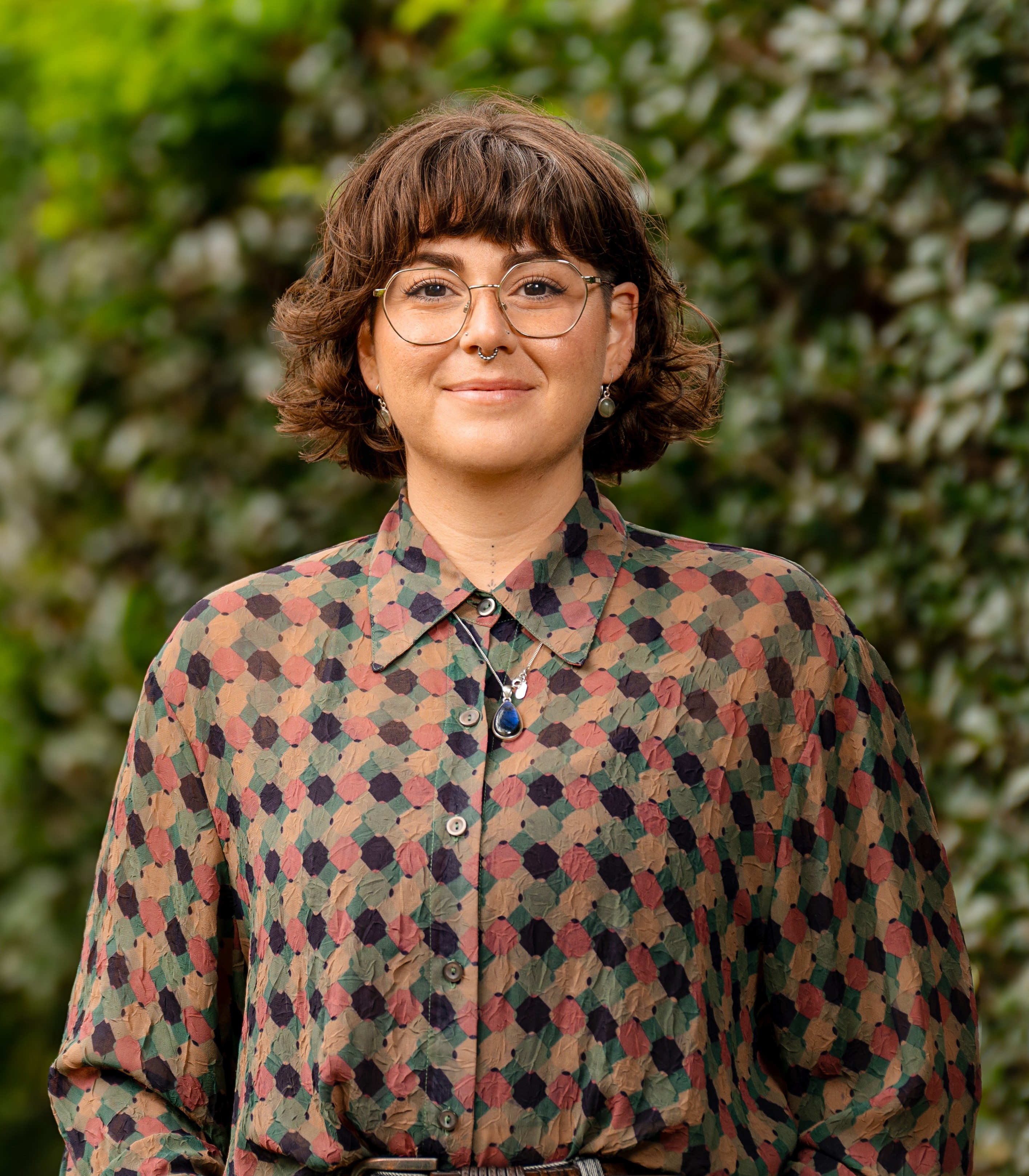 Isabella Litt in front of a leafy green background