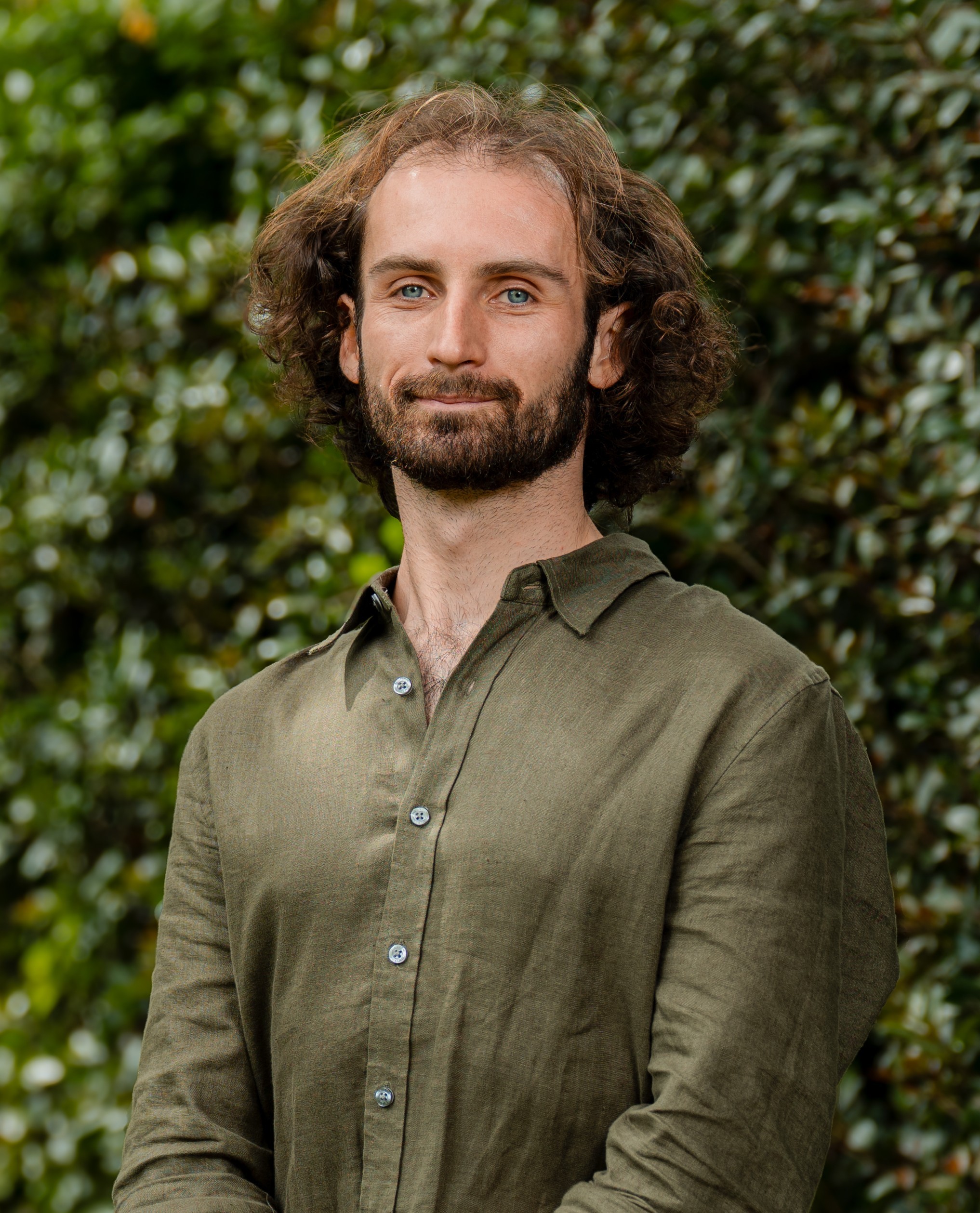 Declan Brumfield in front of a green leafy background