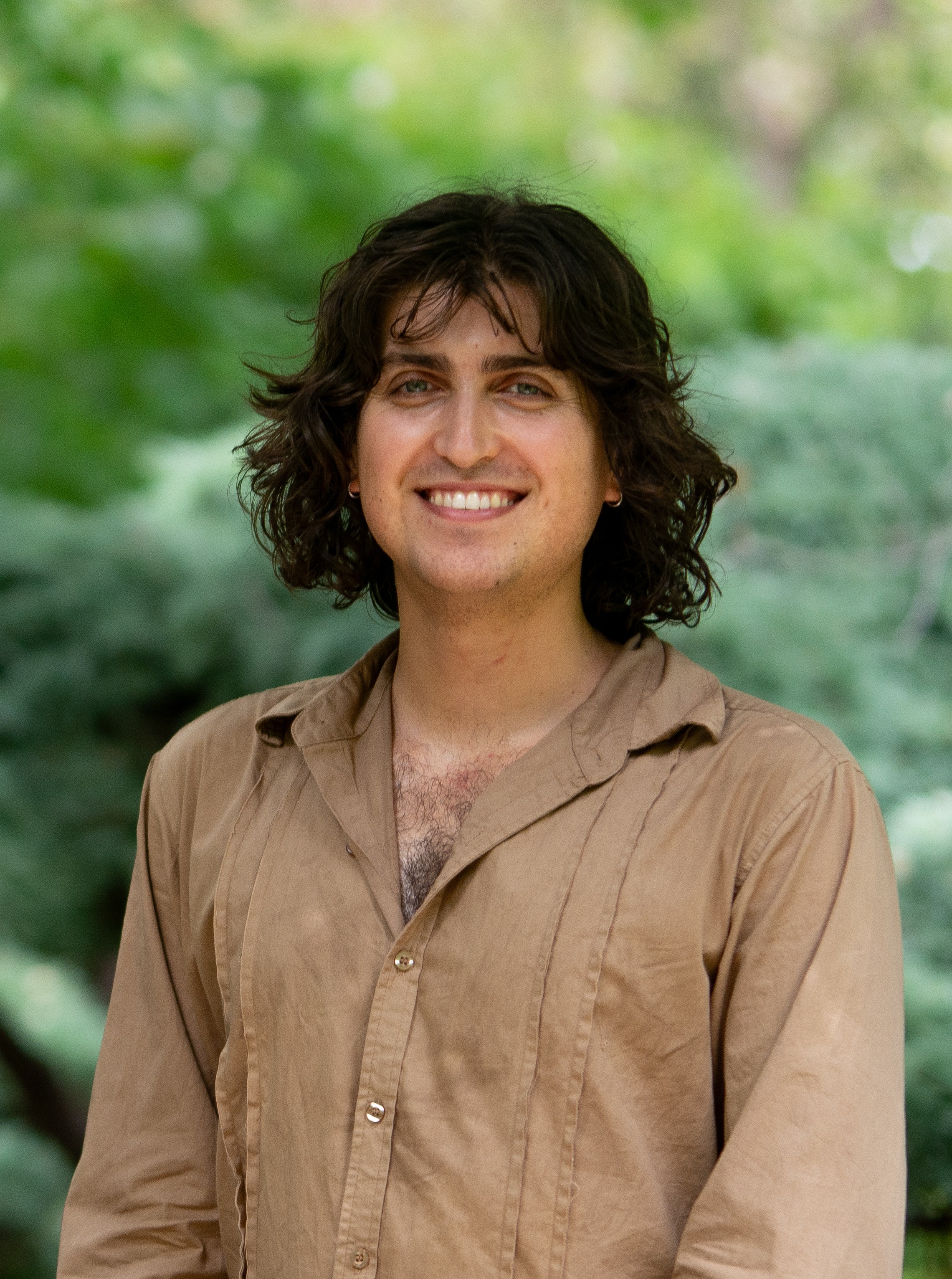 James Scalzi in front of a green leafy background