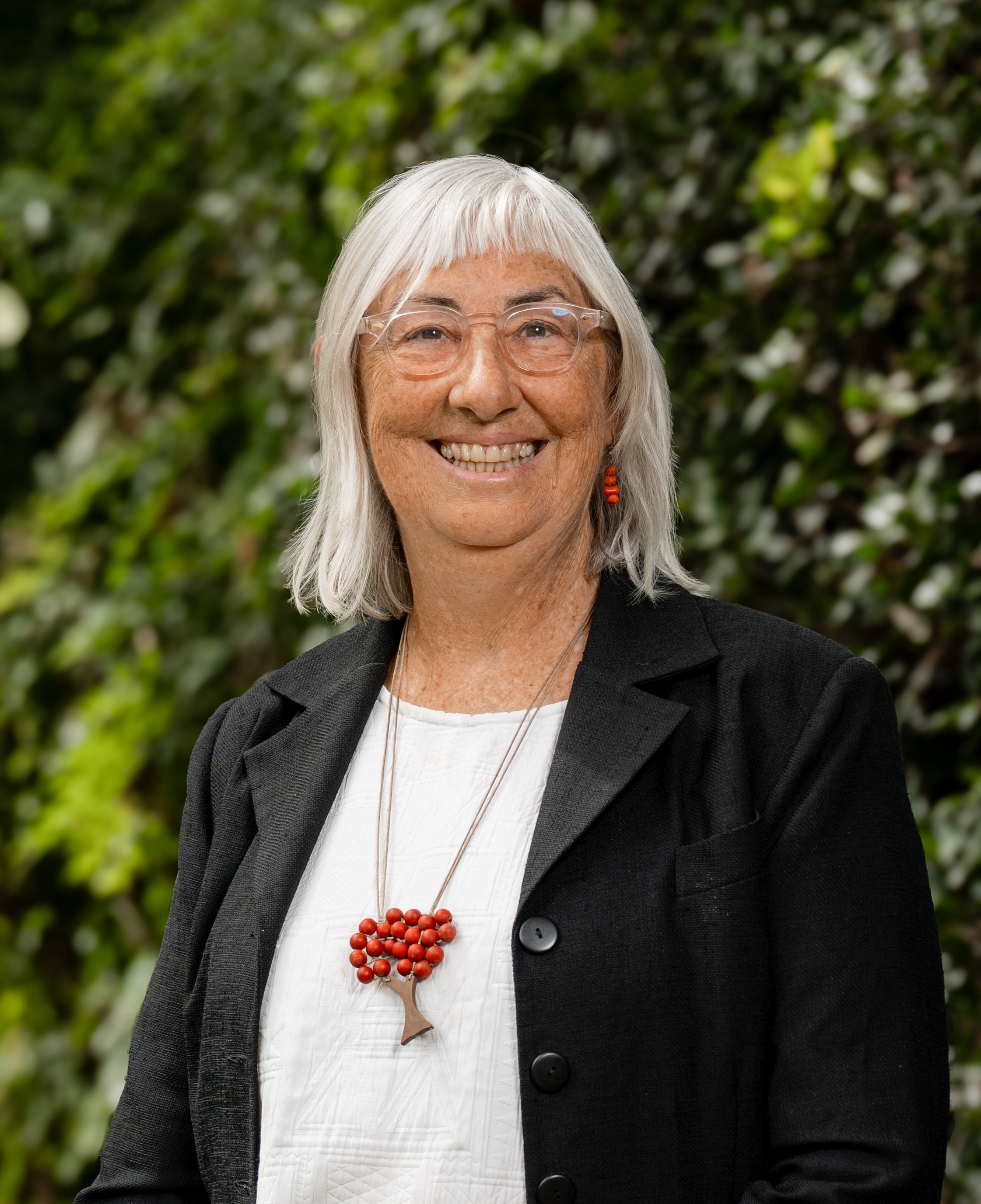 Catherine Olsson in front of a green leafy background