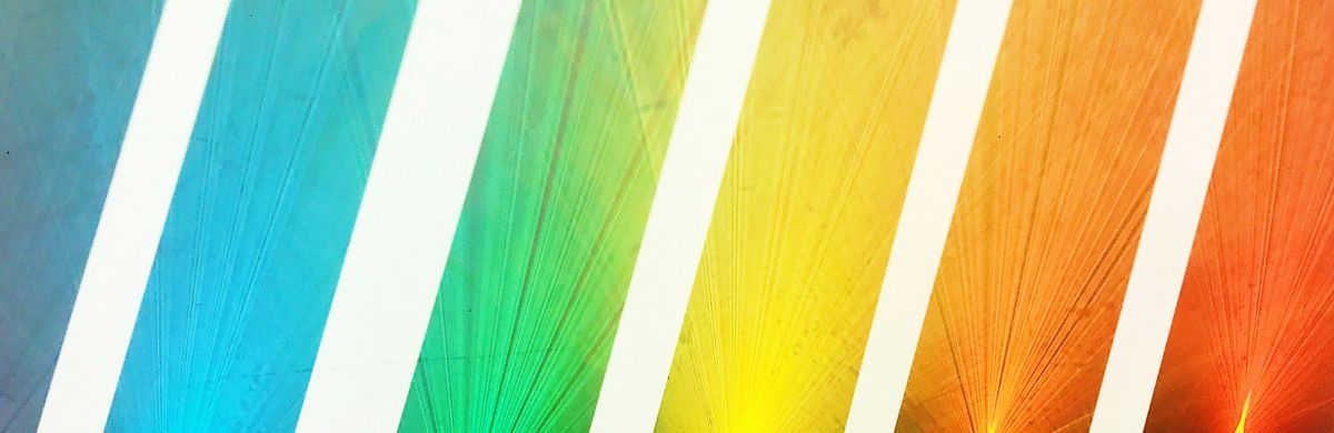 Light refracted through multicoloured glass, creating a spectrum of colours.