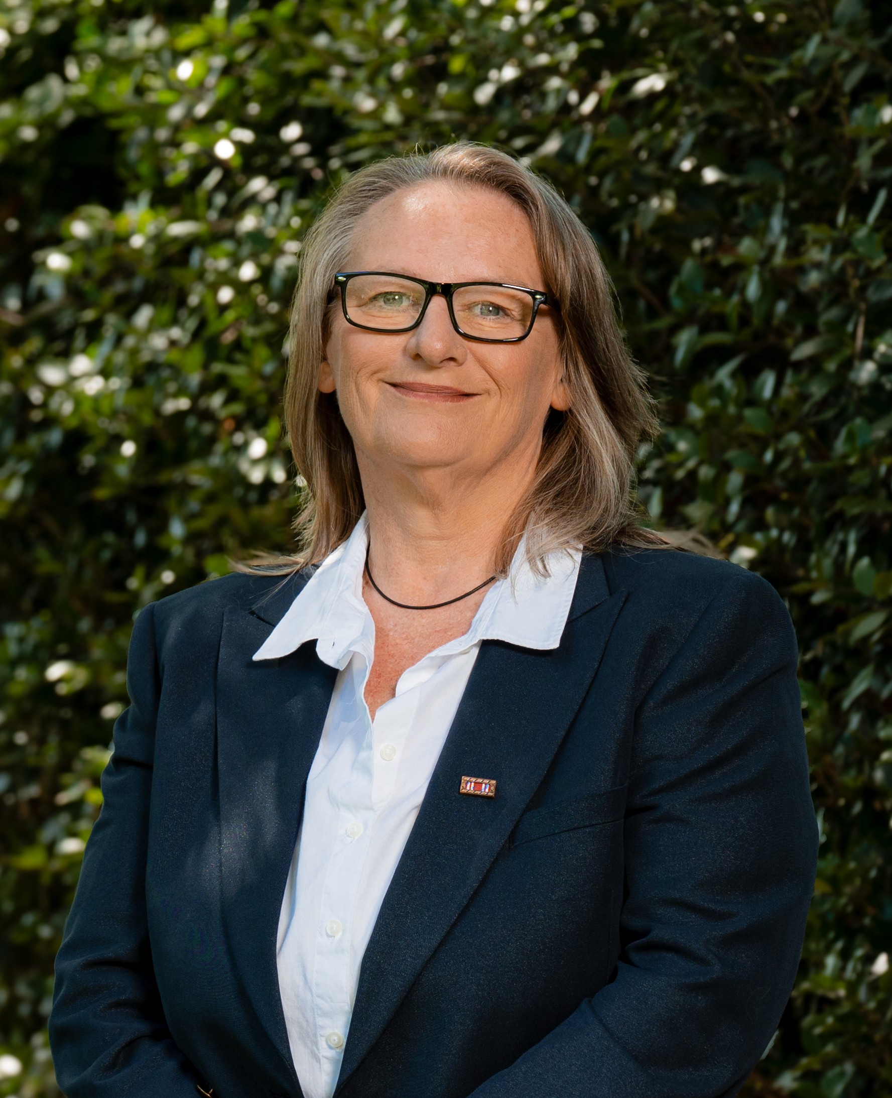 Nicole Palachicky in front of a green leafy background