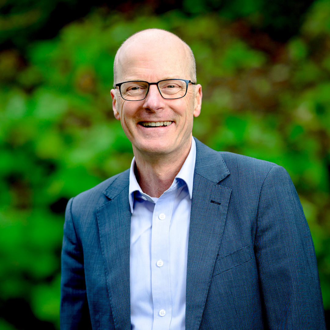 Image of Tim Read MP smiling on a green background