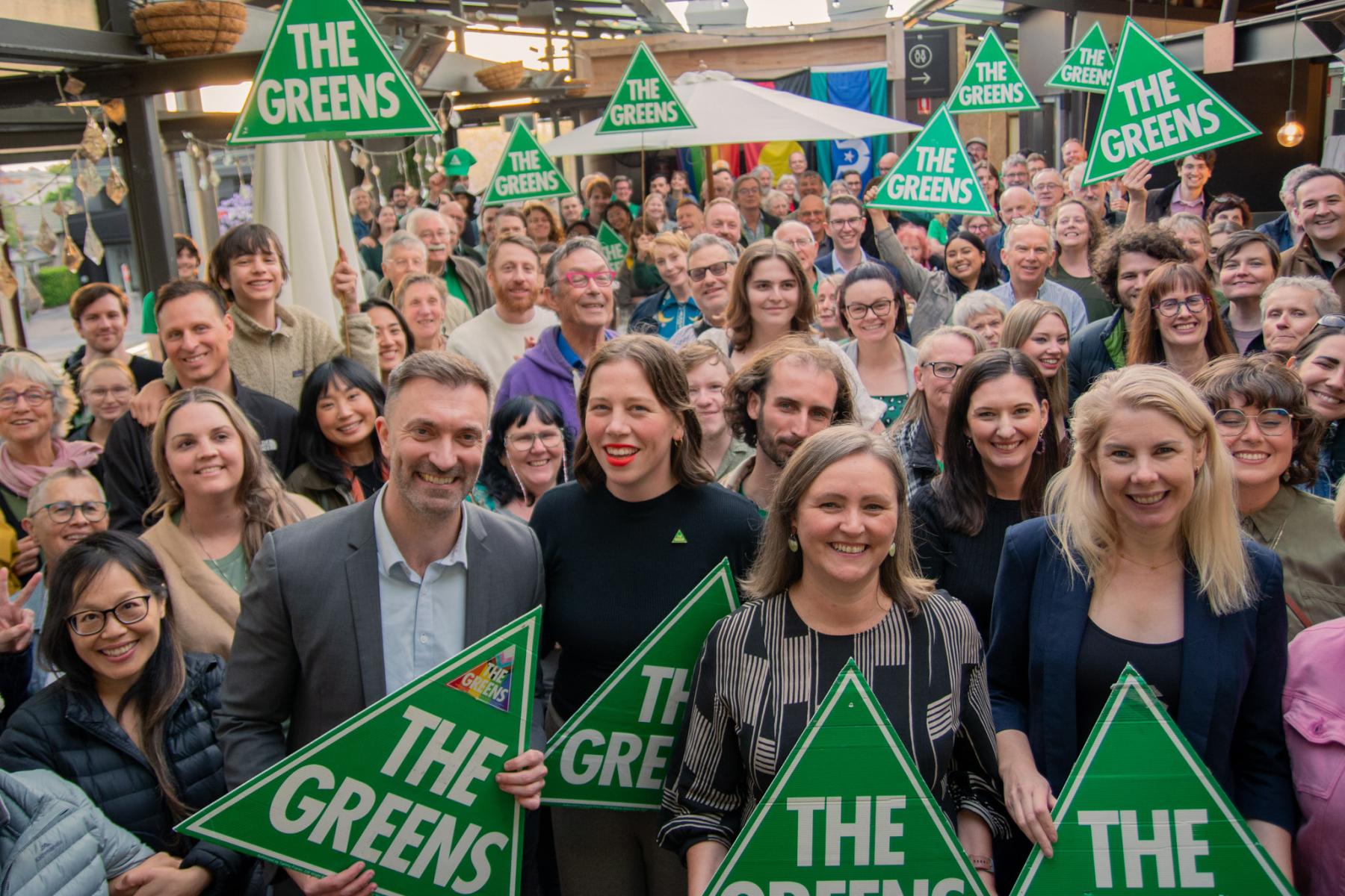 A large group of Greens SA MPs, candidates and supporters holding Greens signs