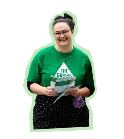 Greens volunteer holding a pamphlet